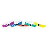 Five colorful wristbands with white polka dots and a black oval buckle, arranged in a row on a plain white background.